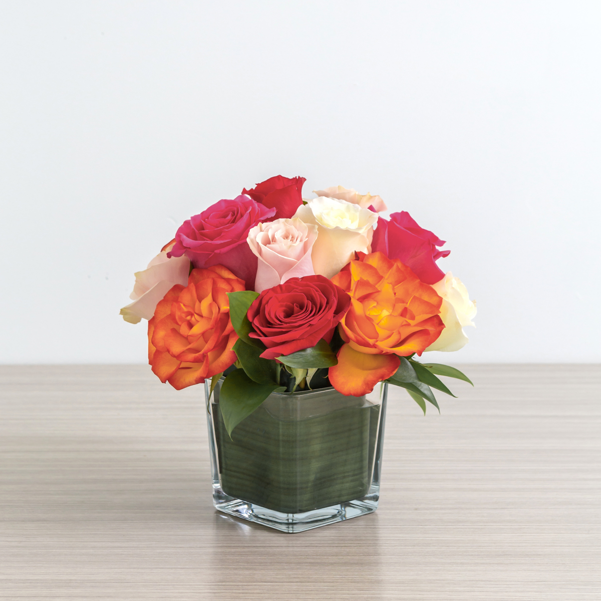 Assorted color roses in a cube vase