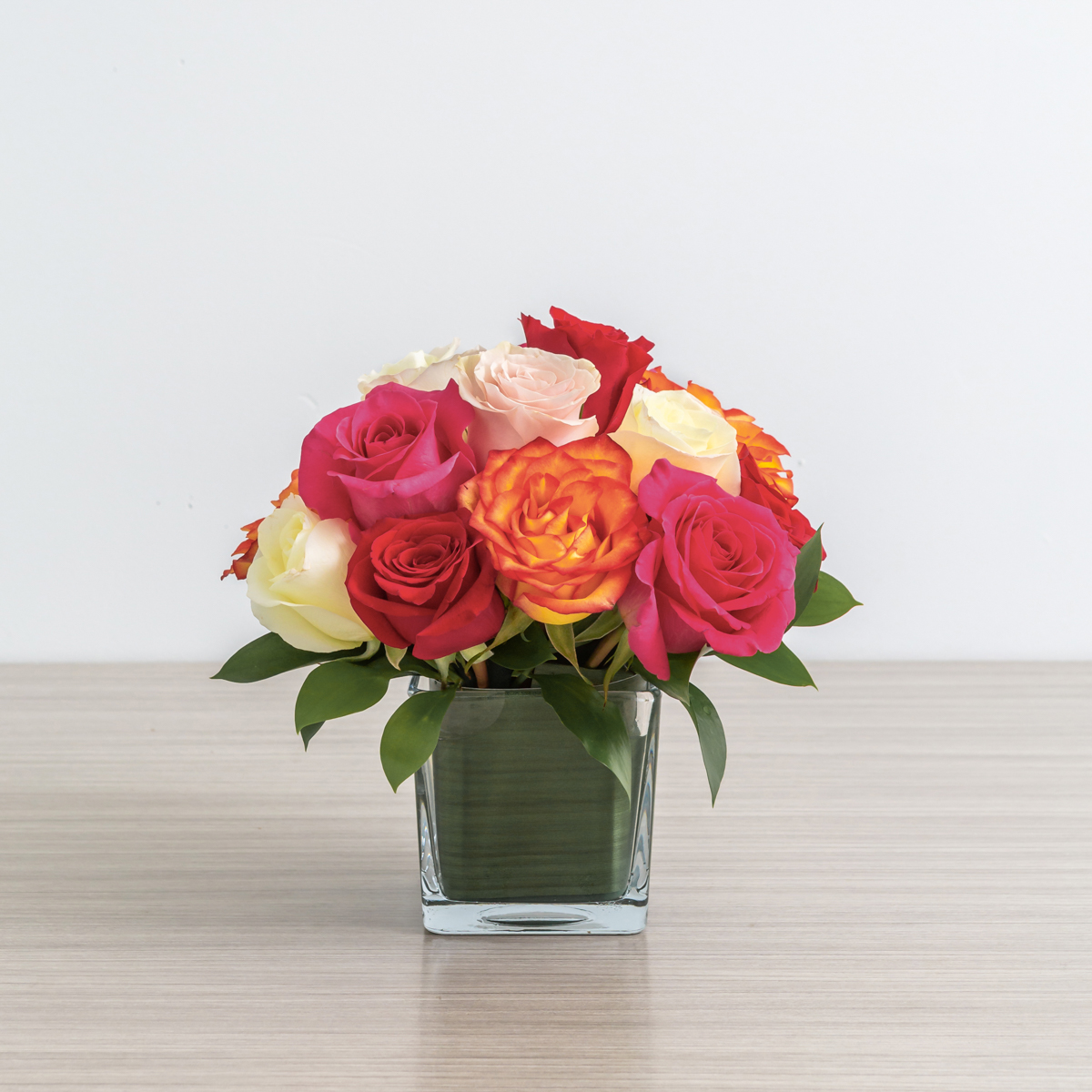 Assorted color roses in a cube vase