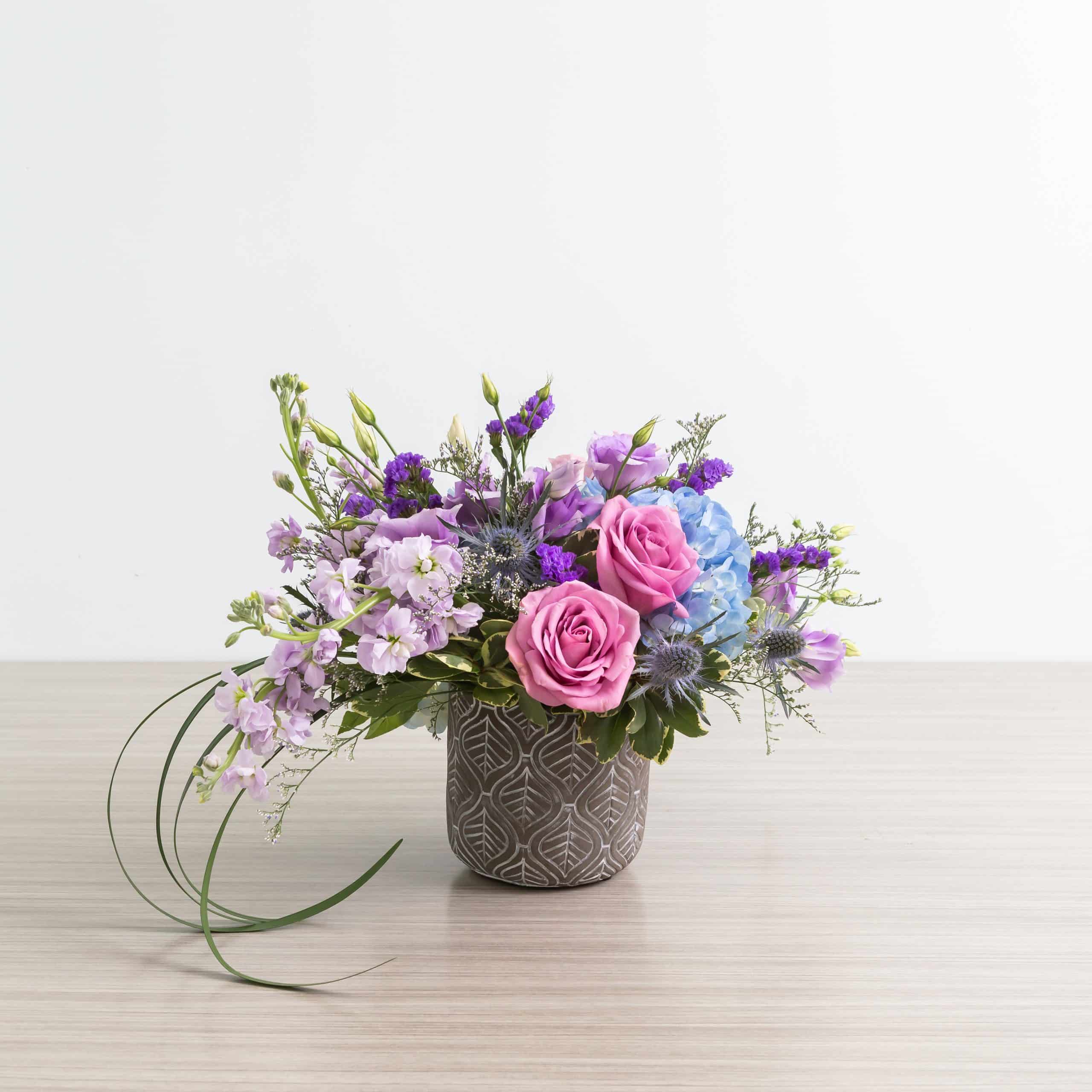 Floral arrangement with Blue dream roses and blue hydrangeas and lisianthus