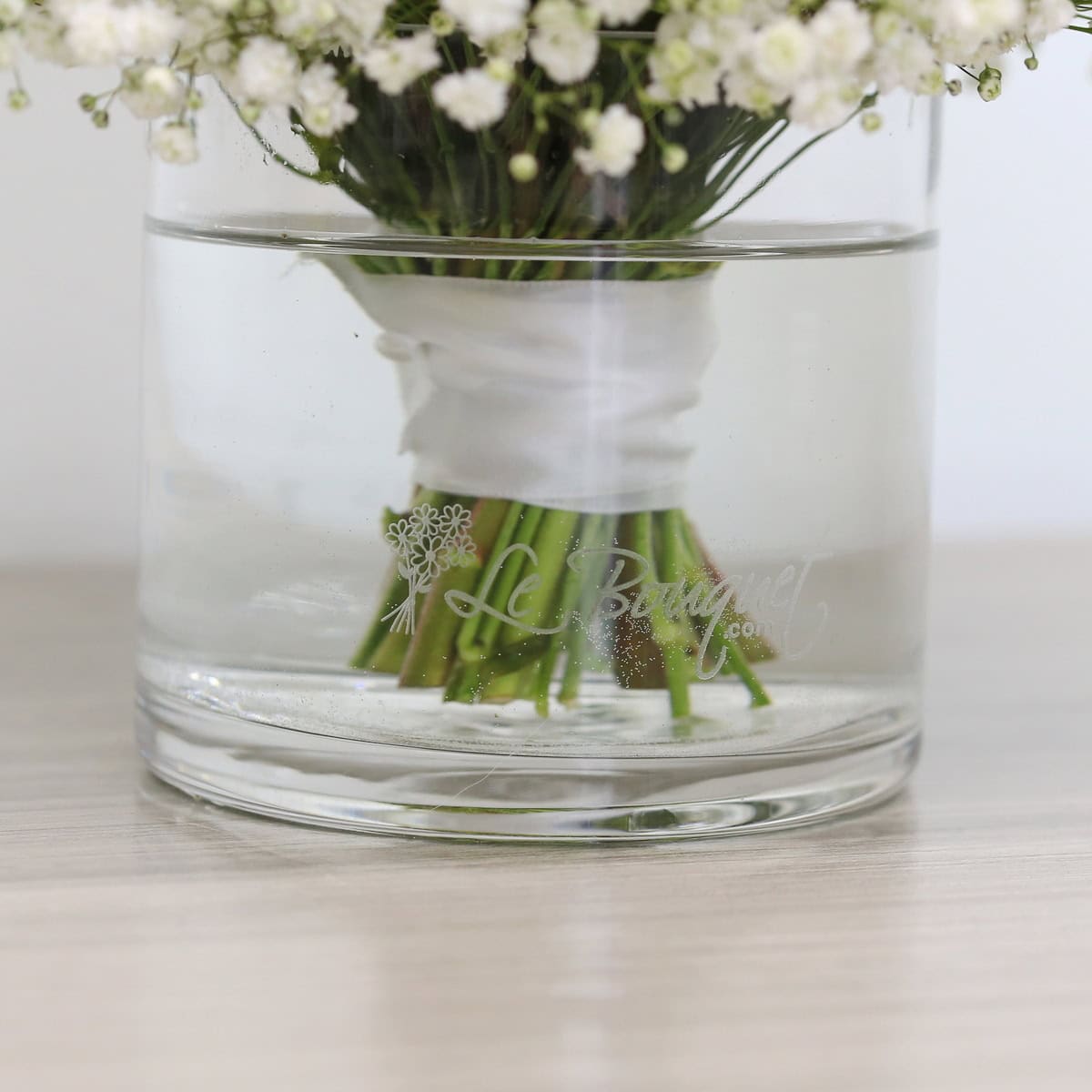 White spray roses bouquet with baby's breath in round and custom vase