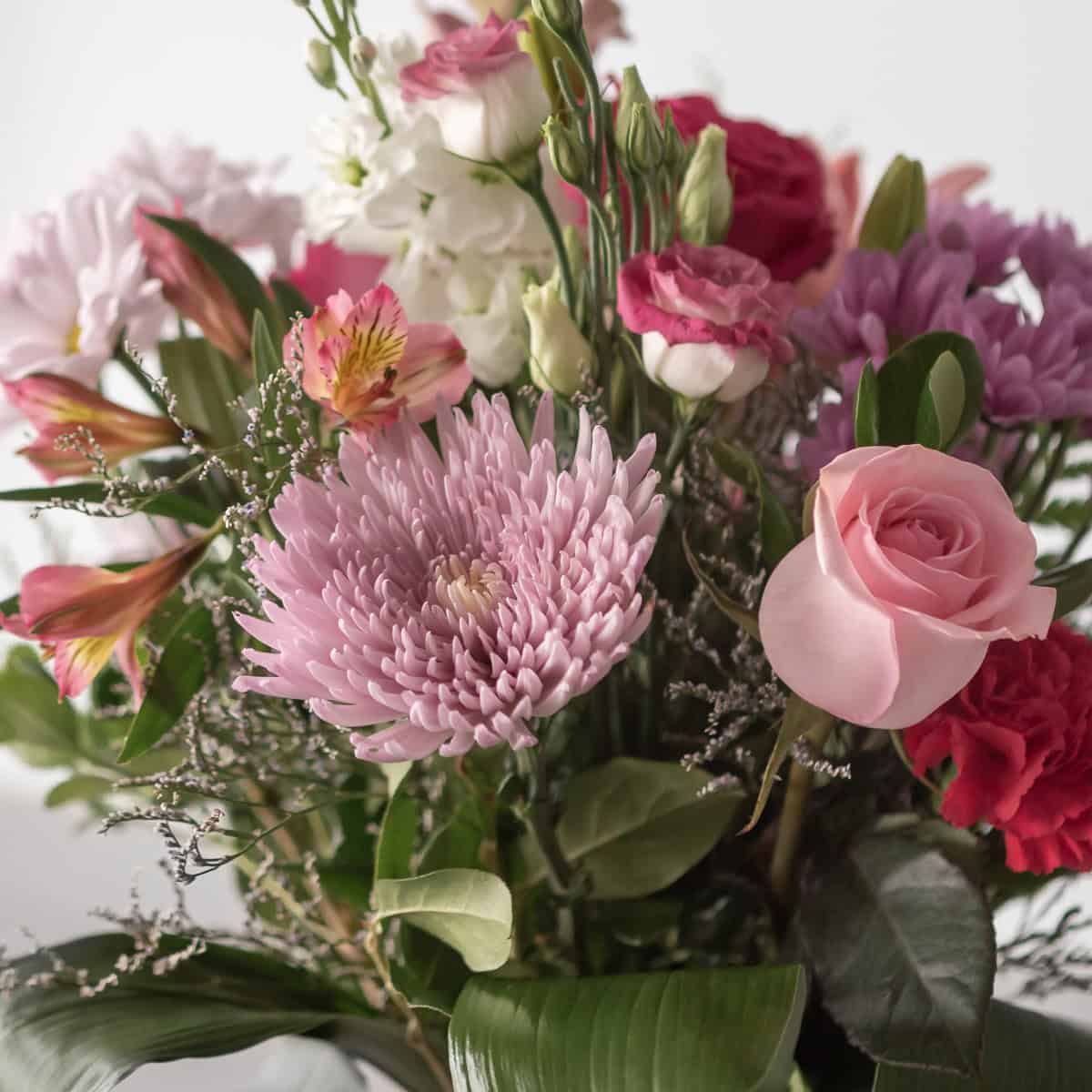 Close-up of Mother’s Day bouquet featuring pink rose, chrysanthemum and mixed blooms