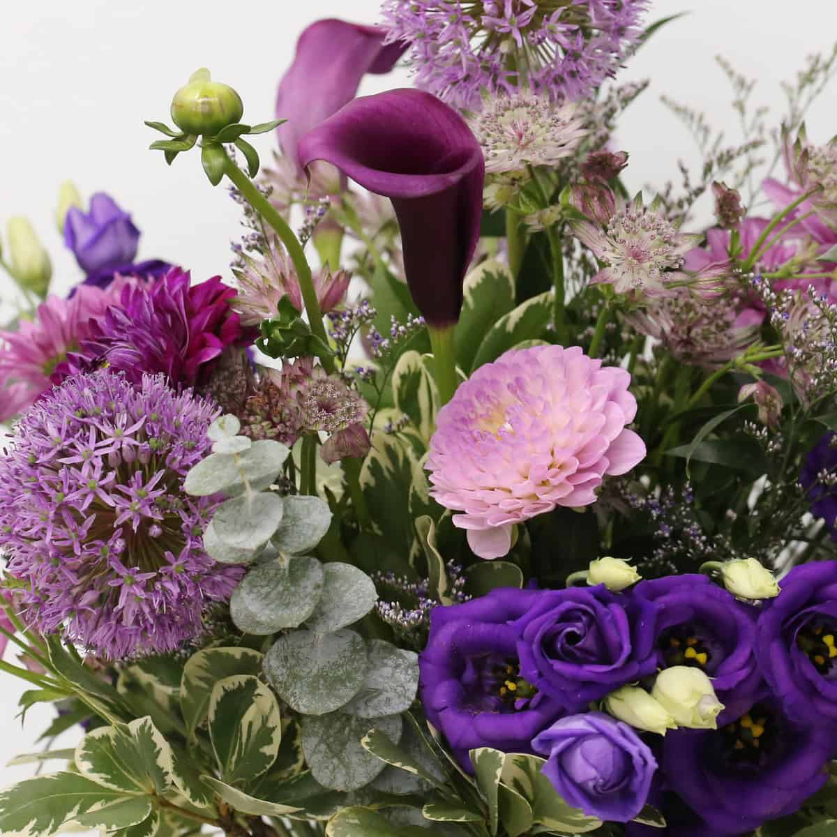 Close-up of Summer Amethyst bouquet with purple calla lilies, allium and lisianthus