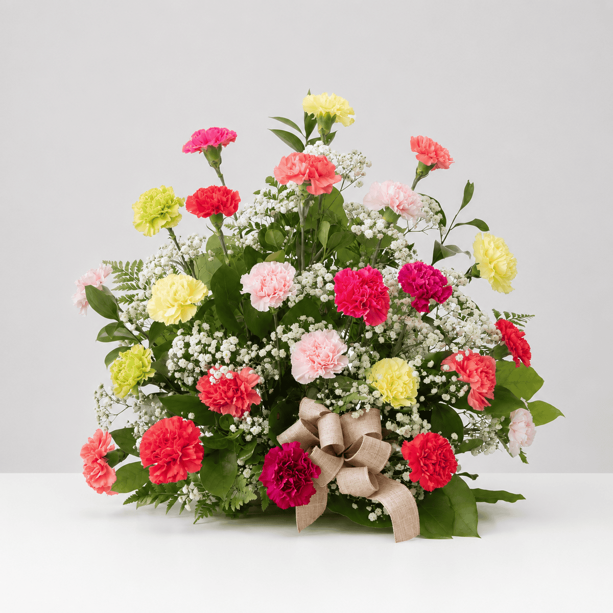 Abundant Carnations arrangement featuring colourful mixed carnations, baby's breath and fresh greenery.