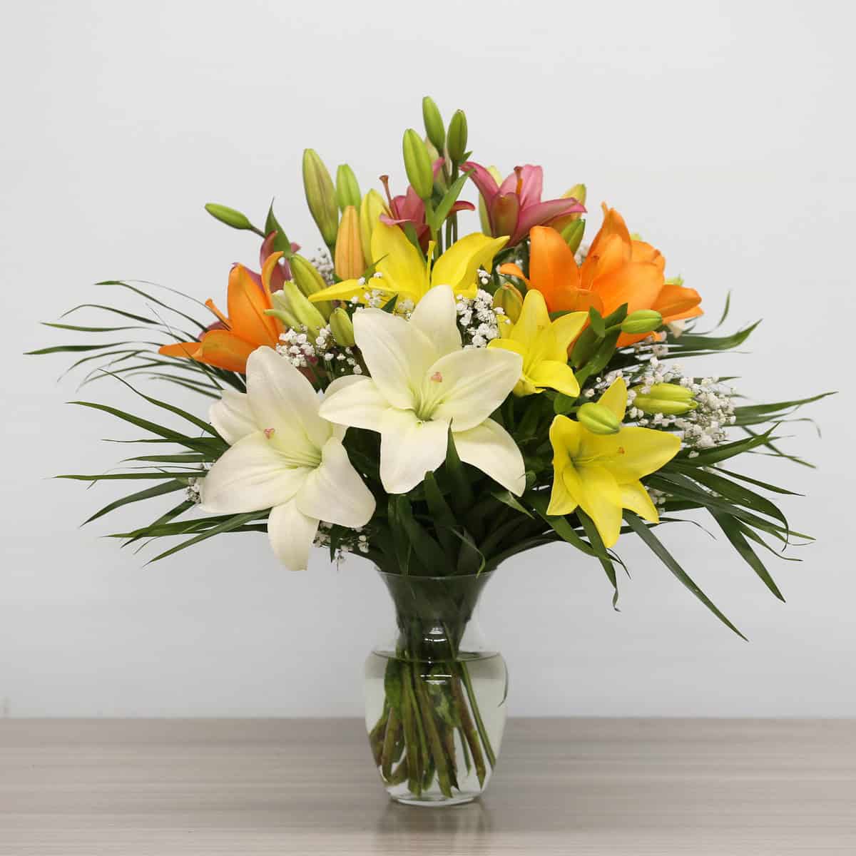 Deluxe colourful Asiatic lily bouquet arranged in a glass vase