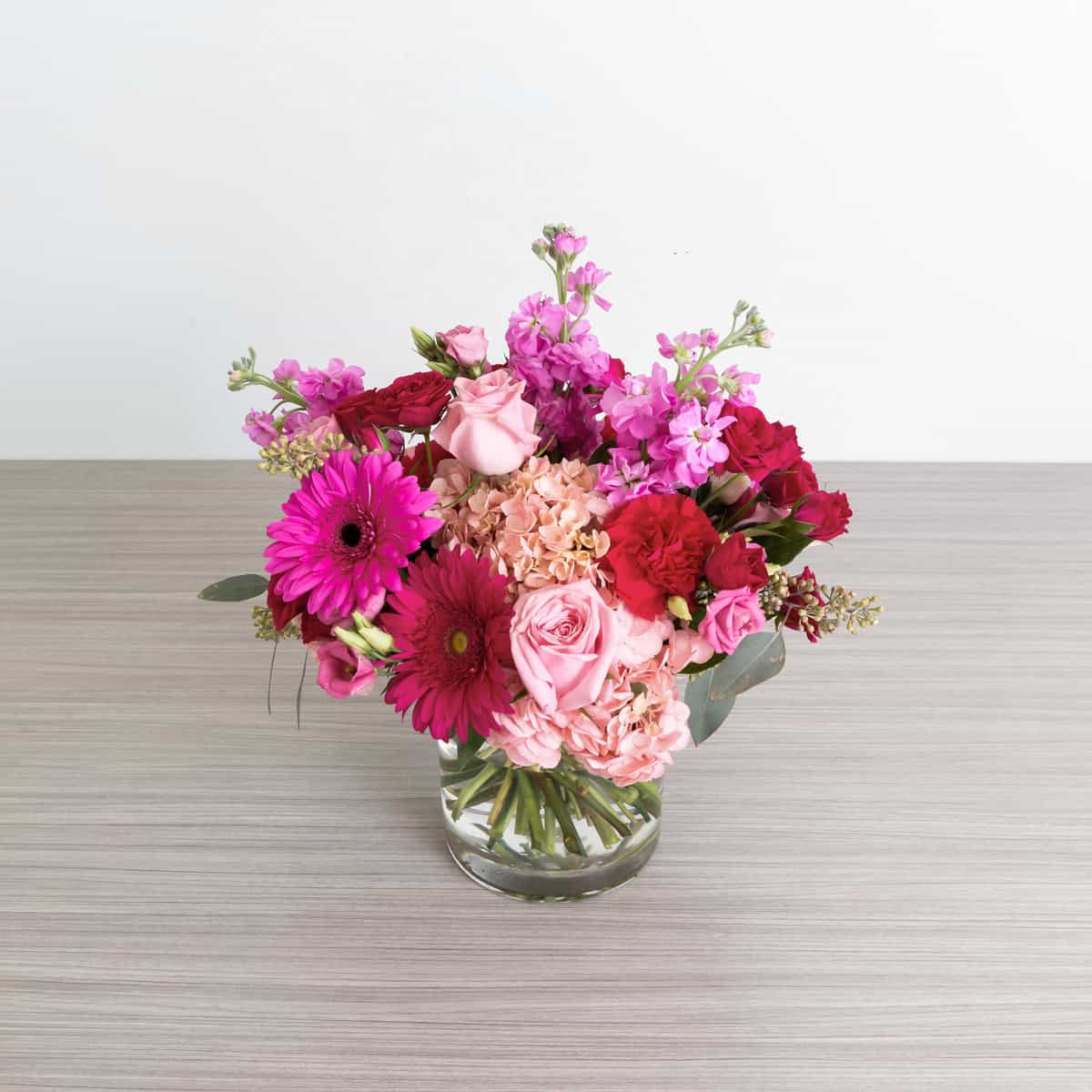 Top view of the Pink Flamingo flower arrangement with pink roses, hydrangea, gerbera daisies, carnations and stock in a glass vase.