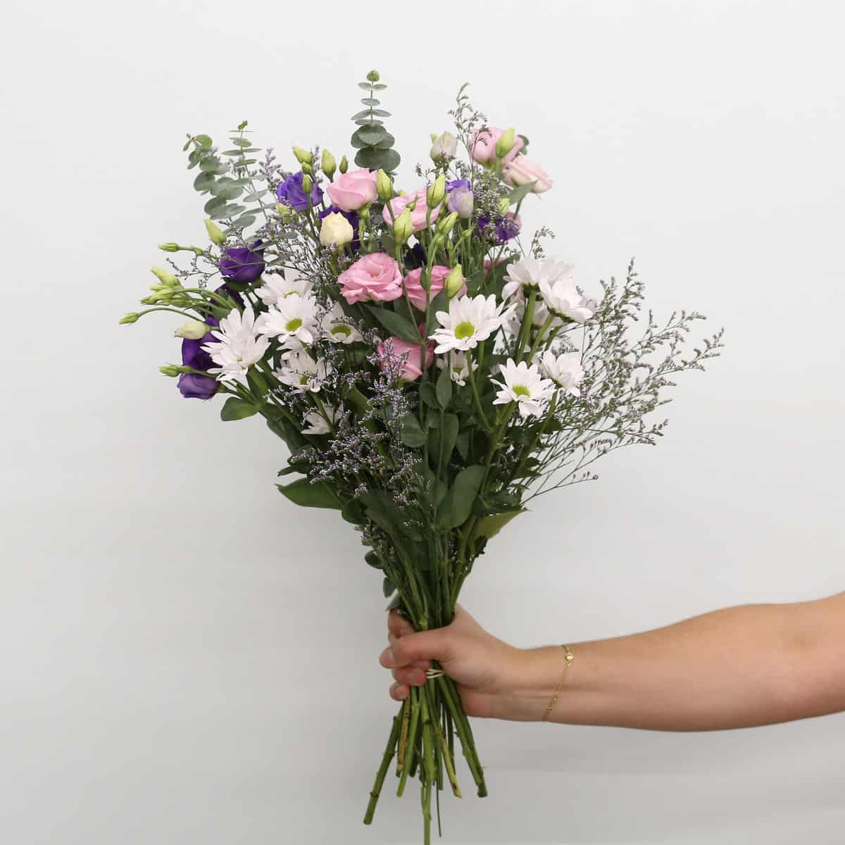Ariana Deluxe hand-tied bouquet with pink and purple lisianthus, white daisies, caspia and eucalyptus
