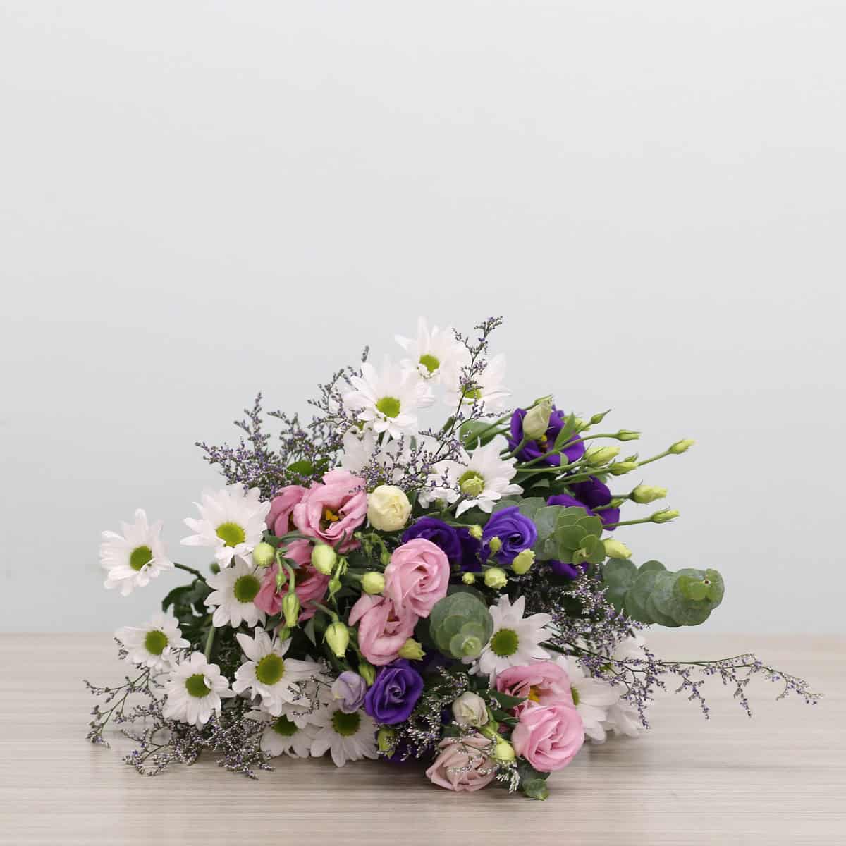 Ariana Deluxe Bouquet with pink and purple lisianthus, white daisies, caspia and eucalyptus
