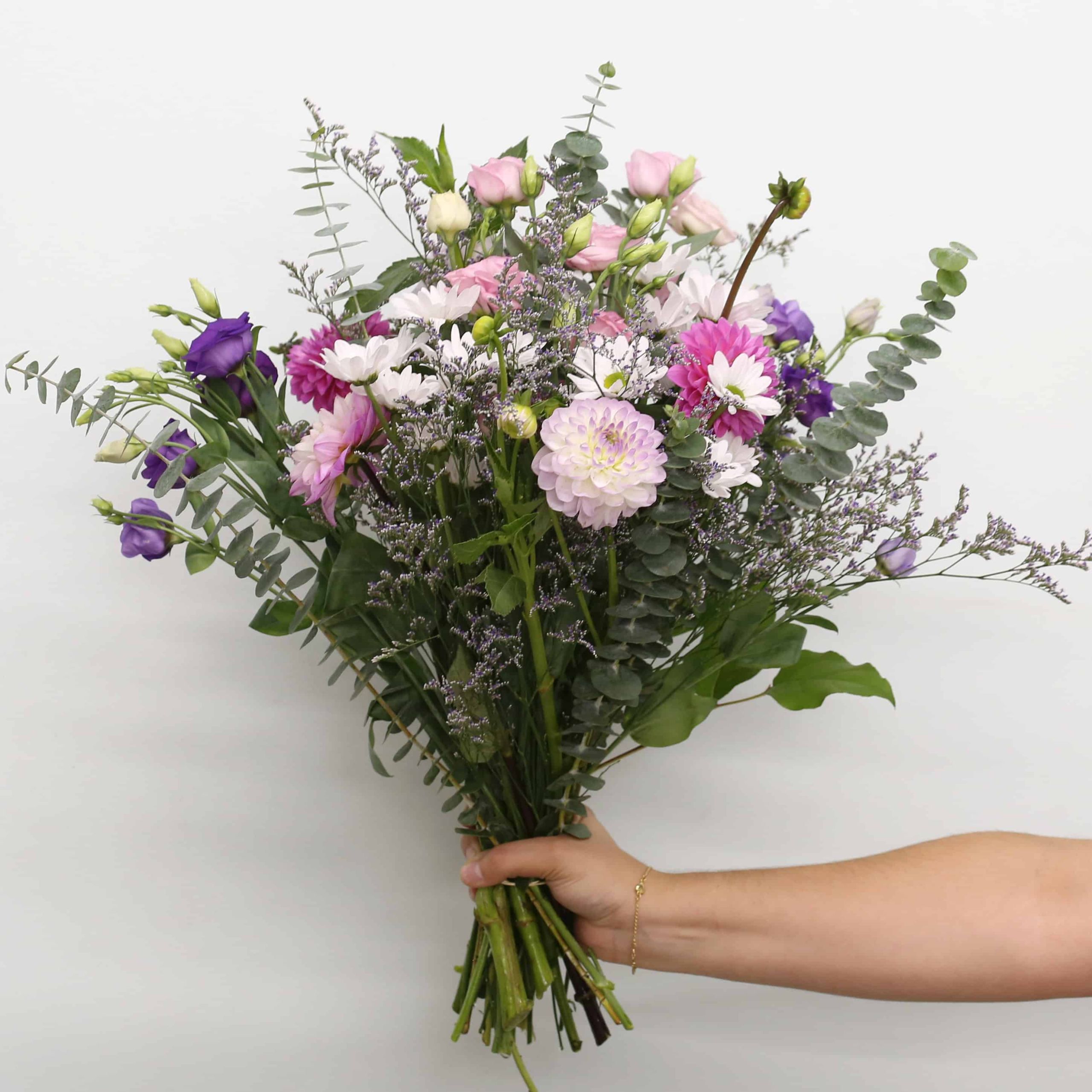 Ariana Premium hand-tied bouquet with pink and lavender dahlias, lisianthus, white daisies, caspia and eucalyptus