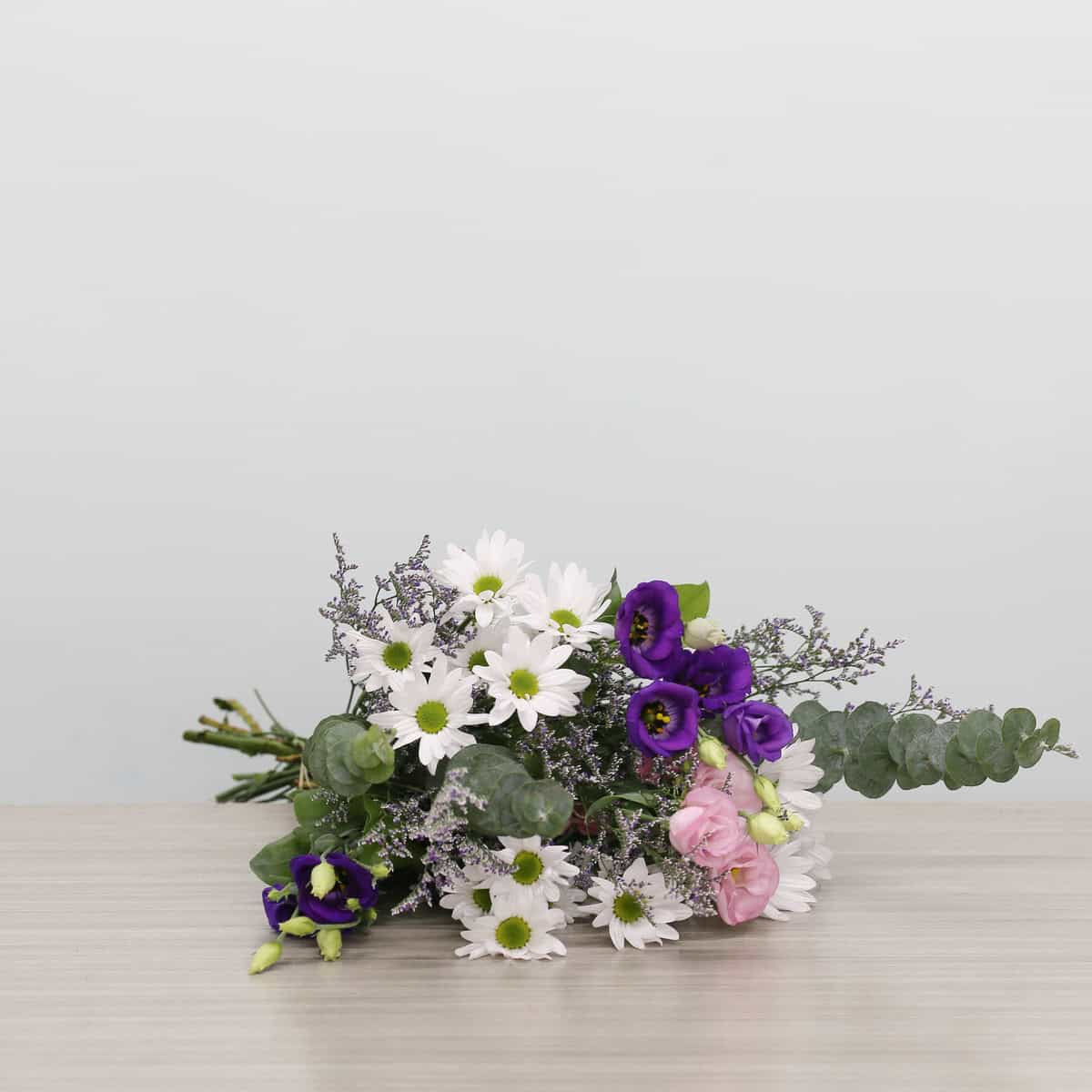 Ariana Standard Bouquet with white daisies, purple and pink lisianthus, caspia and eucalyptus