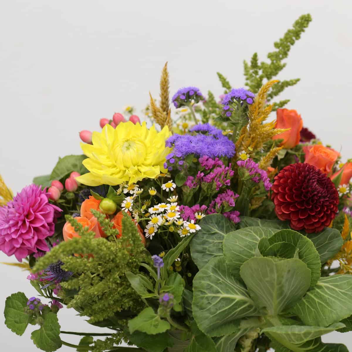 Countryside Charm bouquet close-up with colourful dahlias, roses and seasonal field flowers