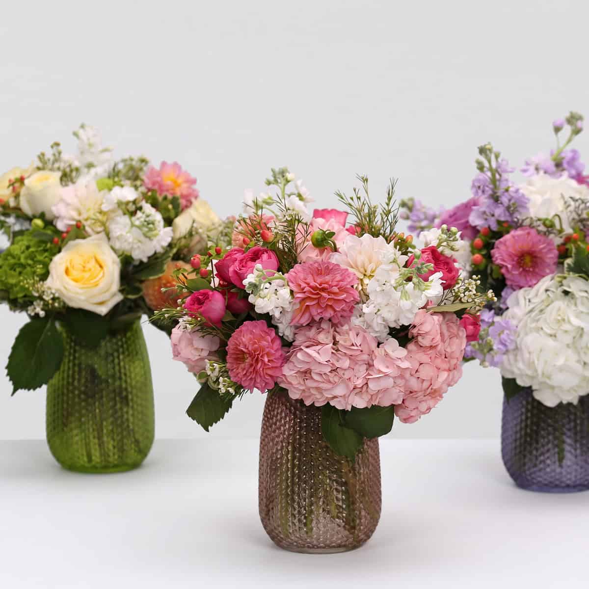 Floral Rhapsody flower arrangements in cream and peach, rose and blush, and lavender and white colour palettes