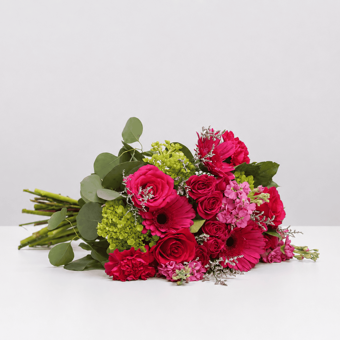 Raspberry Bloom pink flower bouquet with roses, gerbera daisies, carnations, hydrangea, stock and eucalyptus.