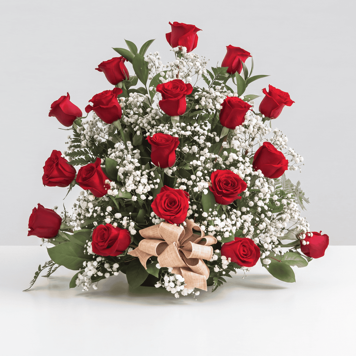 Deluxe Red Rose Rush arrangement with 18 premium red roses, baby's breath and fresh greenery.