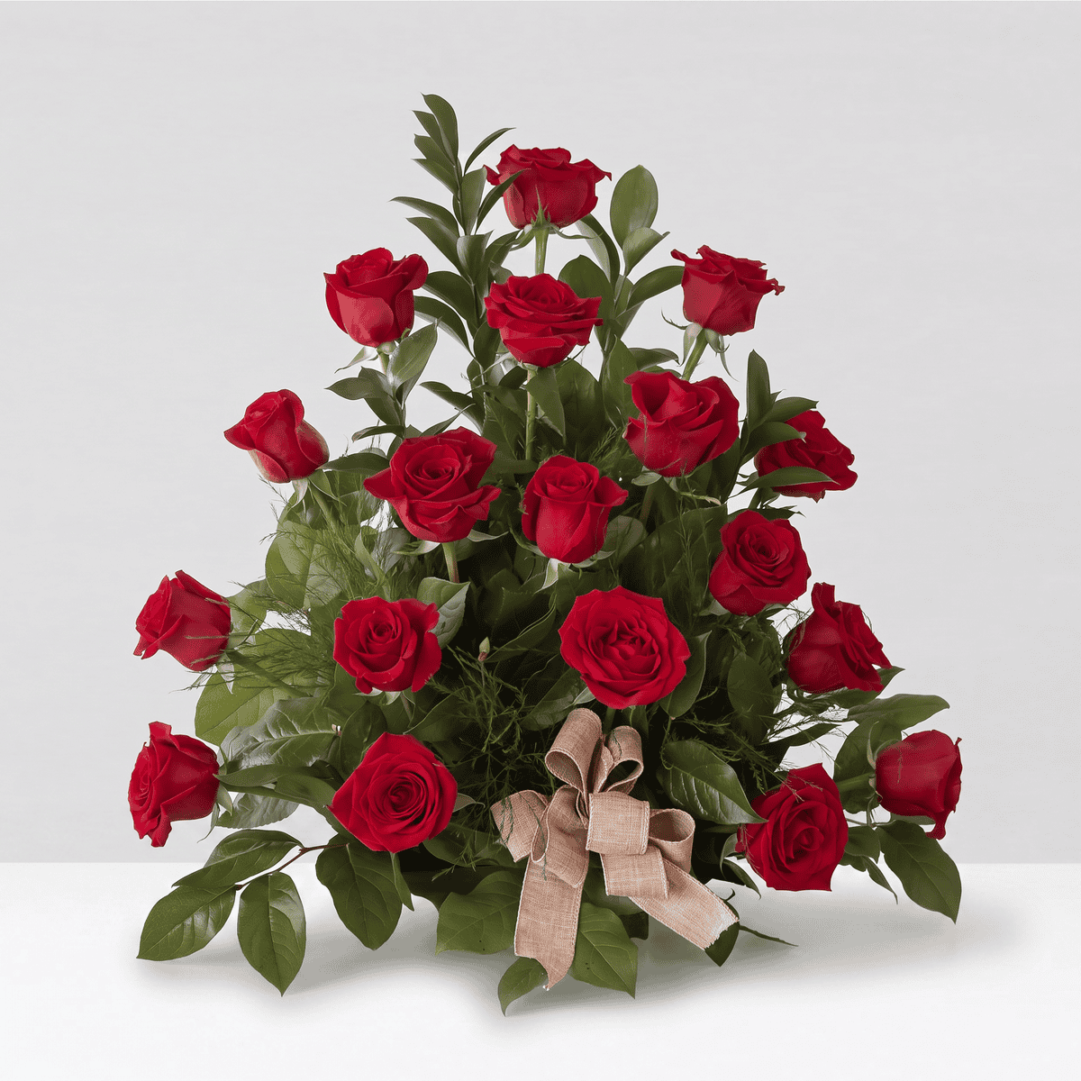 Deluxe Red Rose Rush with 18 premium red roses arranged with lush greenery and burlap bow.