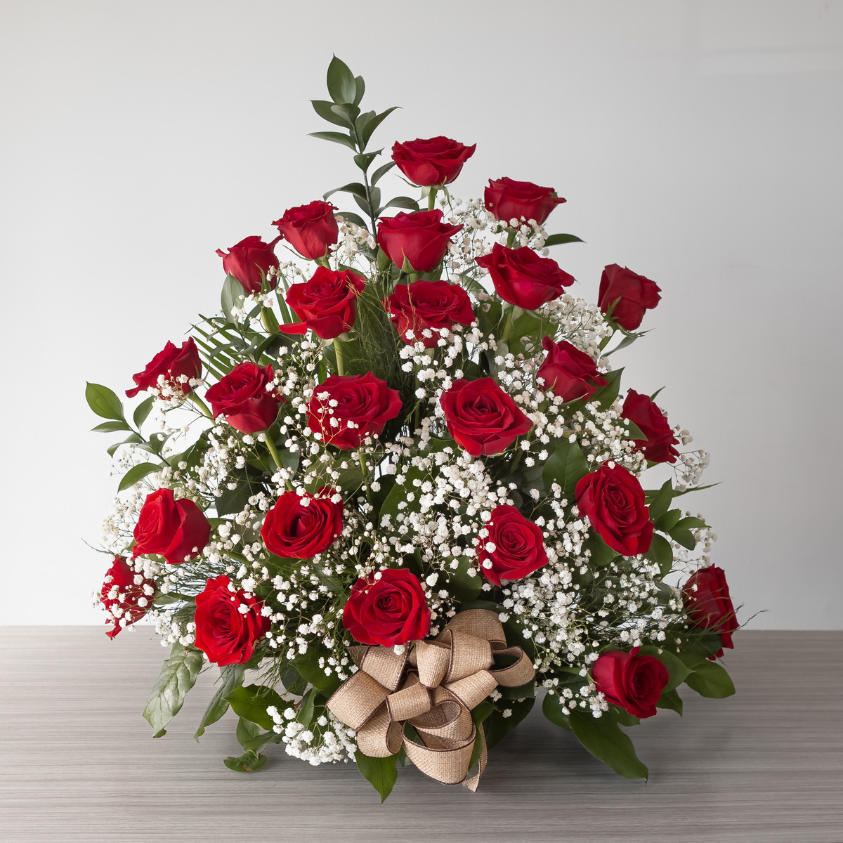 Red Rose Rush Premium arrangement with 24 premium red roses, baby's breath and fresh greenery.