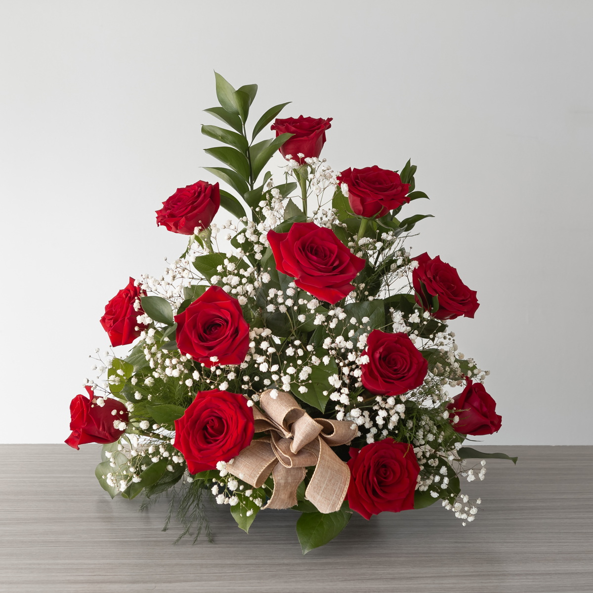 Red Rose Rush standard arrangement with 12 premium red roses, baby's breath and fresh greenery by Le Bouquet Montreal.