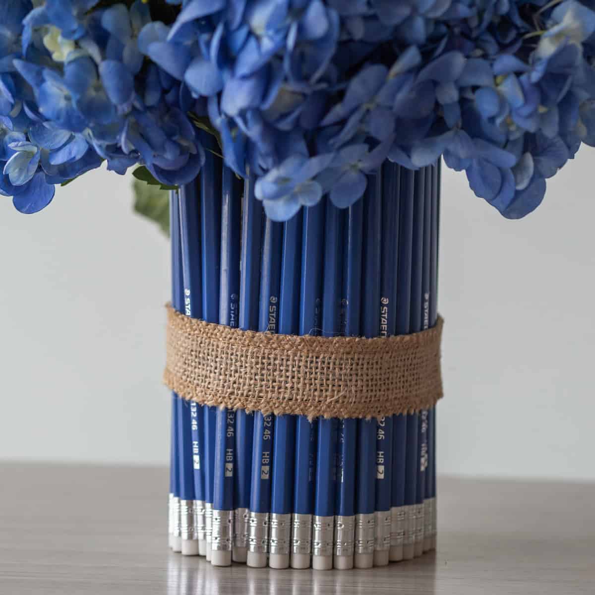 Blue pencil vase detail from the School of Sunflowers floral arrangement